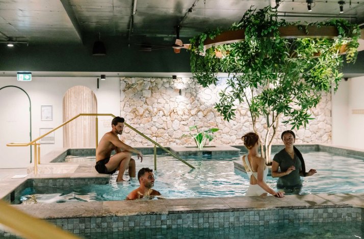 People enjoying a hot magnesium pool at Soak Bathhouse Alexandria.