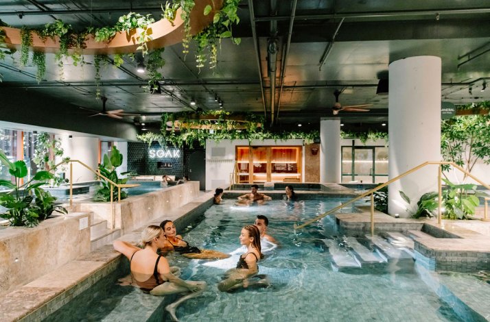 Groups of people enjoying the hot magnesium pools at Soak Bathhouse Alexandria.