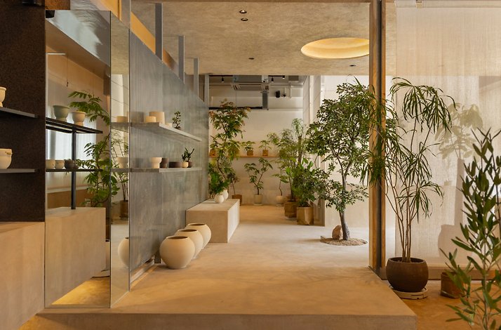 The interior of Soilboy flagship store, showcasing clay color tone and indoor plants.