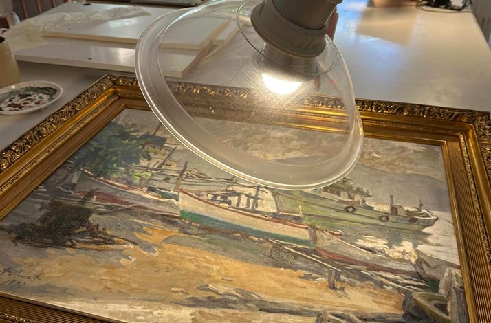 A close-up of a painting's restoration project.