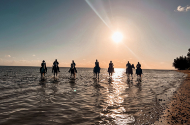 Guided small-group horse-riding adventure in Coral Harbour during sunset.