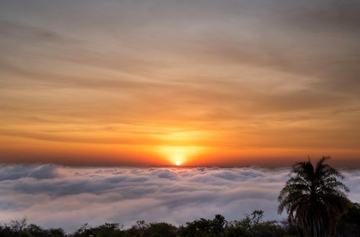 Beautiful sunrise above a blanket of clouds in Akagera National Park.
