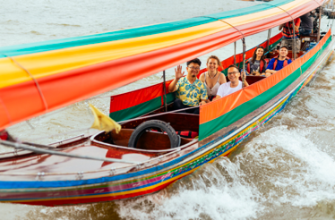 People crossing river in a LongTail Boat in Bangkok.