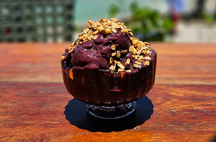 Açaí bowl topped with granola, served after the experience as a nourishing local treat.