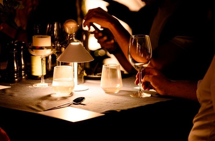 Serving of a table lit up with a tiny table lamp at at A Symphony of Soil & Soul by SecretEATS in South Africa's Highveld.
