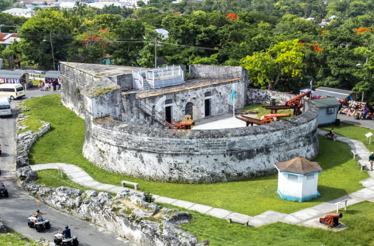 Fort Fincastle in Nassau, historic stone fort with cannons and Bahamian flag.