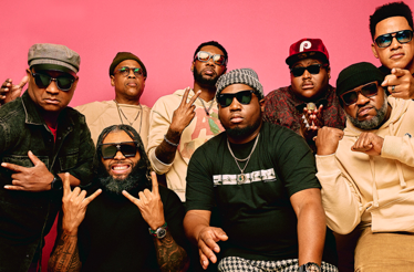 Promotional banner for ensemble The Soul Rebels with saxophonist Karl Denson.