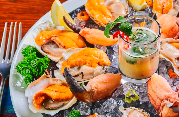 Assorted fresh Chilean seafood served on ice with an appetizer highlighting ocean flavors.