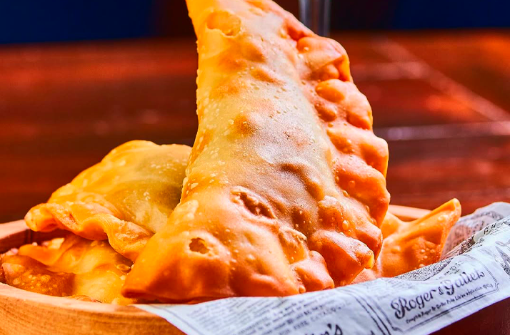 Freshly fried empanadas, a staple of Chilean coastal cuisine served at Aquí Está Coco.