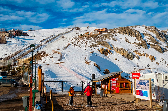 Visitor enjoying snowy slopes at Valle Nevado, surrounded by rugged Andes mountain scenery.