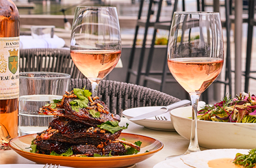 A table served with the dishes of the best New England produce paired with wine at Woods Hill Pier 4.