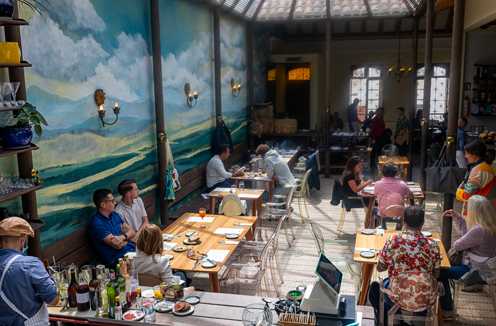 Wide view of Prudencia Restaurant dining room with guests