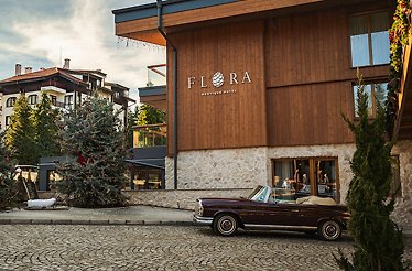 The exterior of Flora Boutique Borovetz with an oldtimer car parked outside