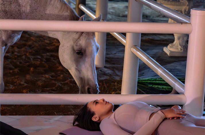 Dubai wellness expert Reem Tahoun laying on the ground as part of her meditation class.