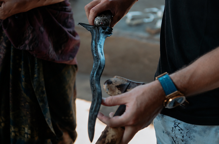 Close-up of a traditional Balinese keris blade held by a master keris maker.