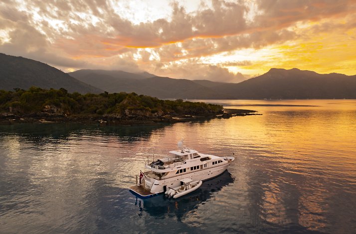 Luxury yacht cruising at sunset in the Whitsundays.