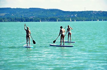 A group of 3 people paddle boarding over calm waters, enjoying scenic views, and disconnecting from the everyday rush as whether solo or with someone special, it's a relaxing yet refreshing outdoor experience.