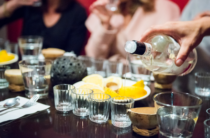 Mezcal being poured into tasting glasses during a guided tasting experience.