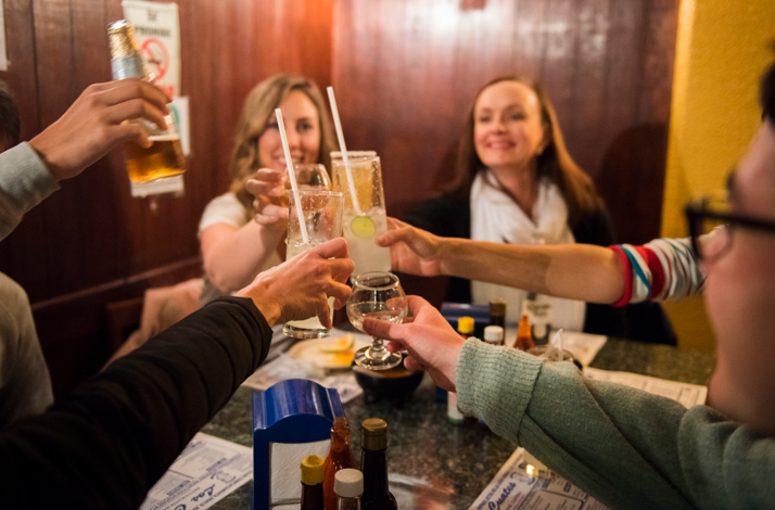 Guests clinking glasses with mezcal and cocktails during the food tour.