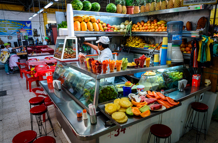 Fresh fruit juice stand at a market.