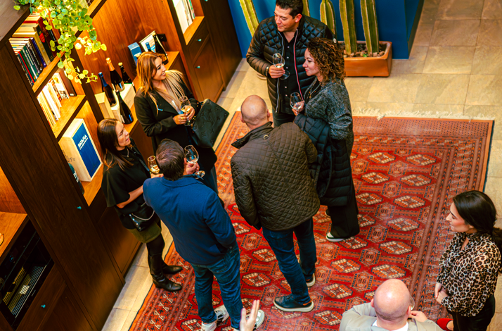 Small group discussing wine and climate inside a private tasting space.
