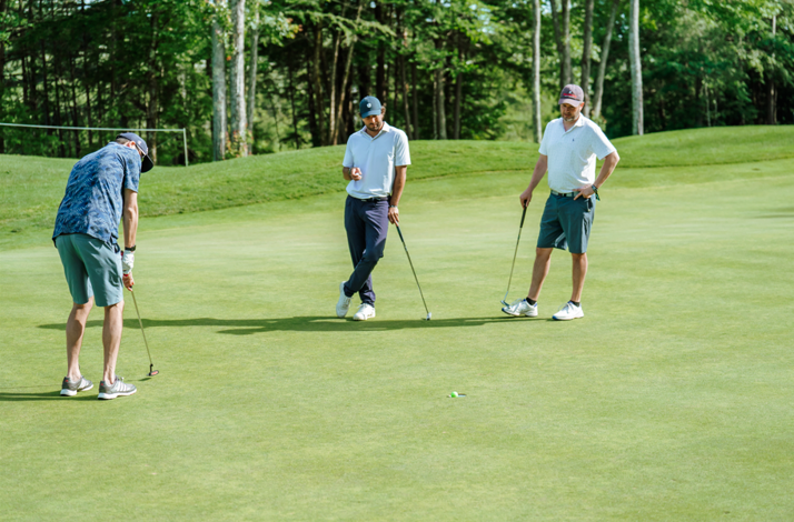Three men playing golf on a friendly golf tournament.