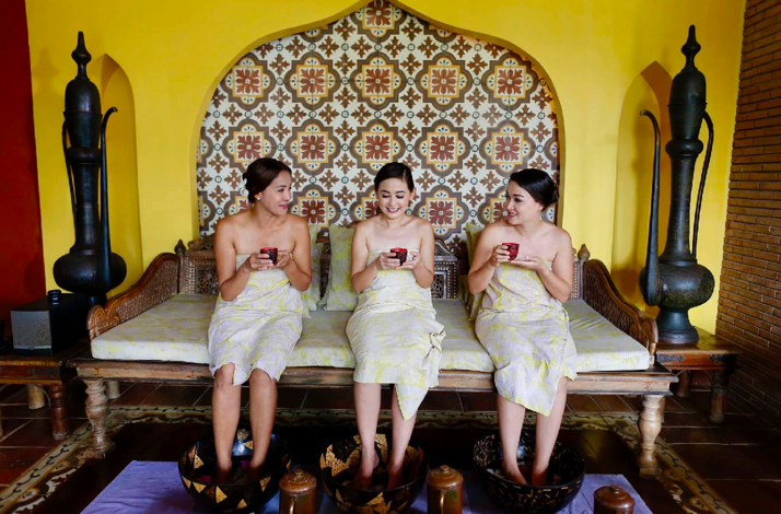 Three people receiving foot soak treatments at Tirta Spa in Boracay, Philippines.