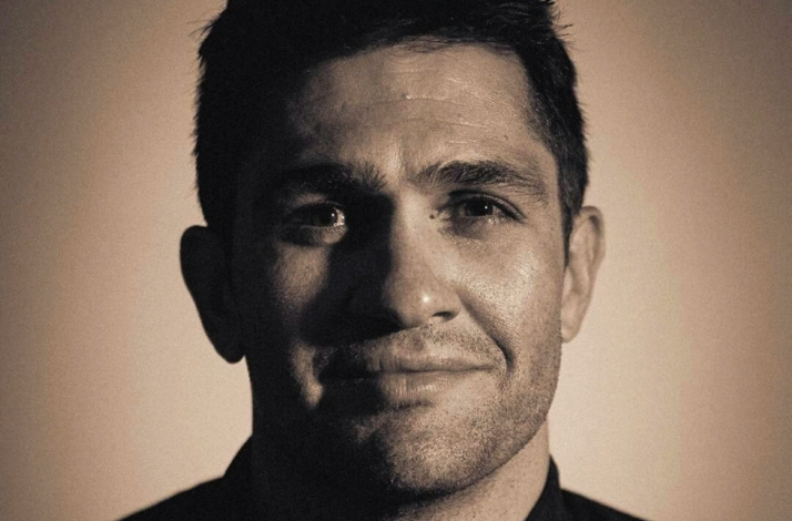 Chef in close-up sepia-toned portrait, wearing a dark jacket, linked to Nairobi Supper Club dining event.
