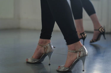 Close-up of women’s feet in tango shoes.