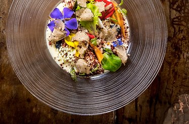 Gourmet Umbrian dish with truffle and edible flowers served in Restaurant Trippini.