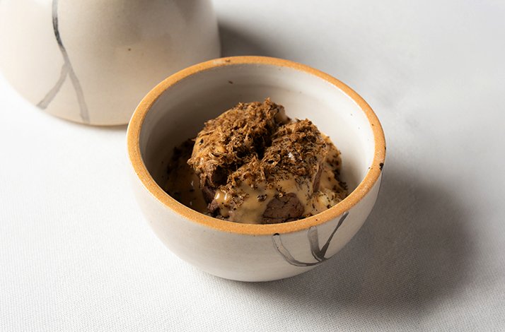 Refined plated dish with rich sauce and truffle at L’Erba del Re restaurant.