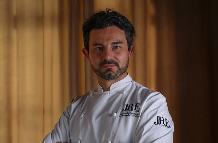 Chef Leonardo Fiorenzani wearing a white JRE chef's jacket at La Sosta del Cavaliere.