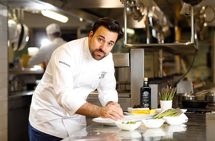 Chef Massimiliano Mascia preparing fresh asparagus in the kitchen at Ristorante San Domenico.