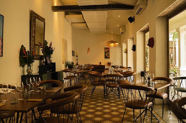 Carmen - Main dining room in the restored colonial home, with terracotta leather chairs