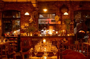 Rustic interior and open kitchen of restaurant Peasant.