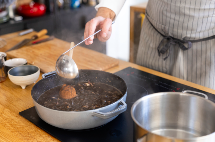 Chef stirs Dalmatian black risotto.