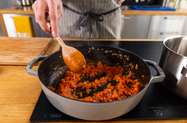 Chef sautés vegetables for a Dalmatian black risotto.