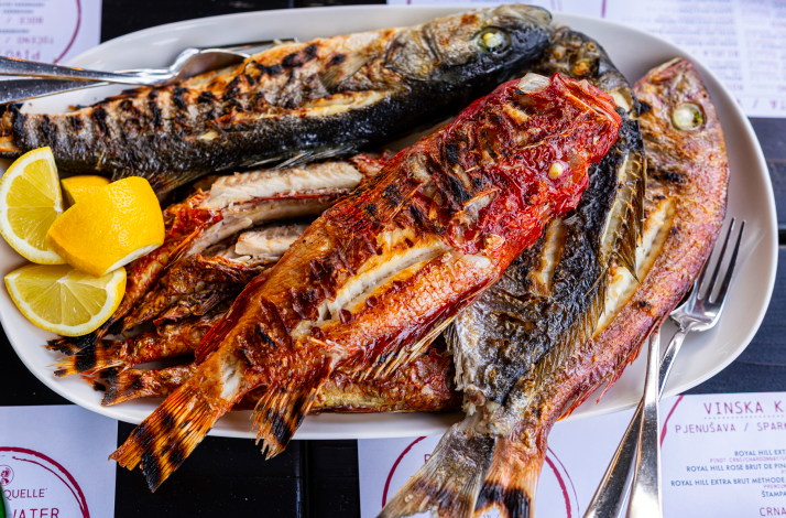Dalmatian grilled fish with Swiss chard served with lemon slices.