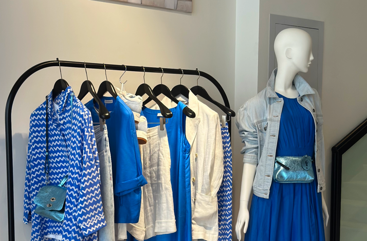 A display of blue and white spring apparel on hangers and a mannequin inside the Cashmere and Silk boutique in Tashkent.