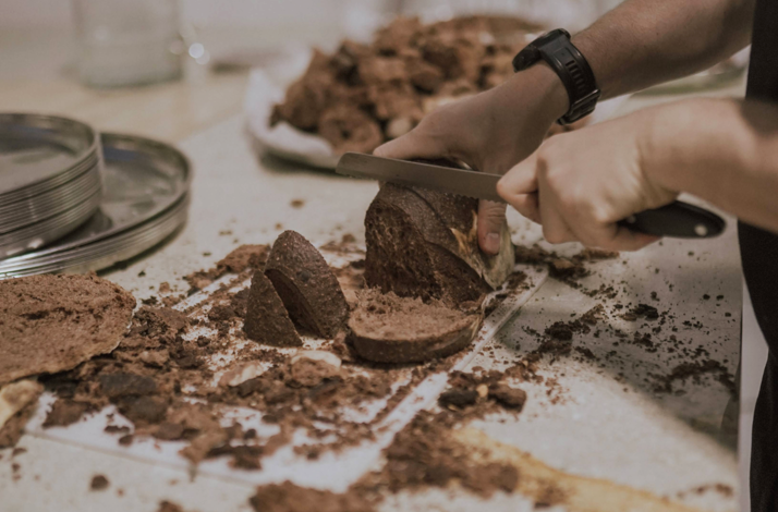 Person slicing Colombian chocolate.