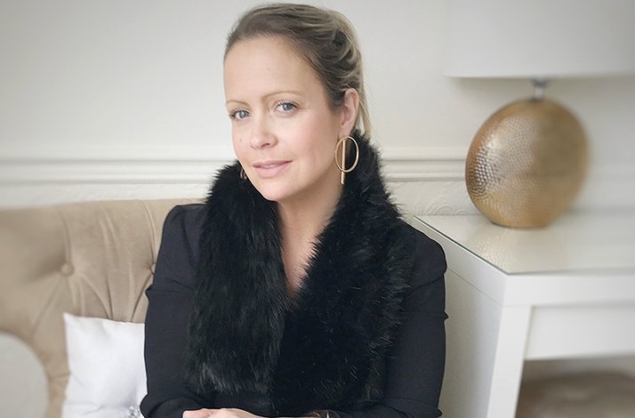 Portrait of fashion stylist Sharon Warten on a sofa