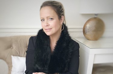 Portrait of fashion stylist Sharon Warten on a sofa
