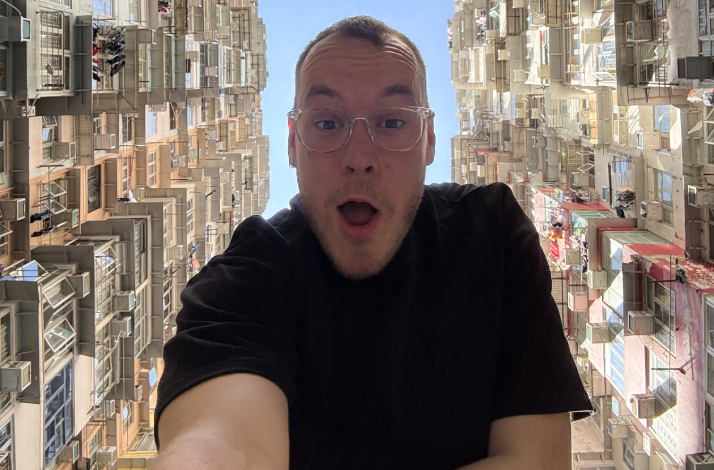 Content creator Marko Vuletić posing in between tall apartments.