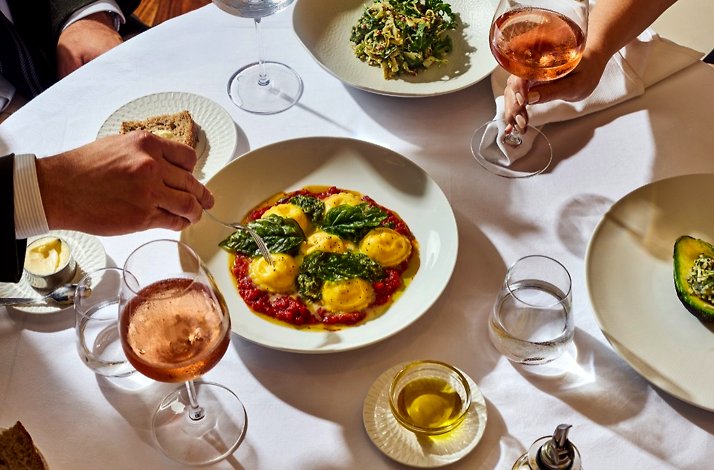 Main dishes paired with glasses of wine served at Marea Beverly Hills.