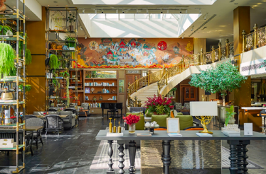 Elegant hotel lobby with grand staircase and lounge seating.