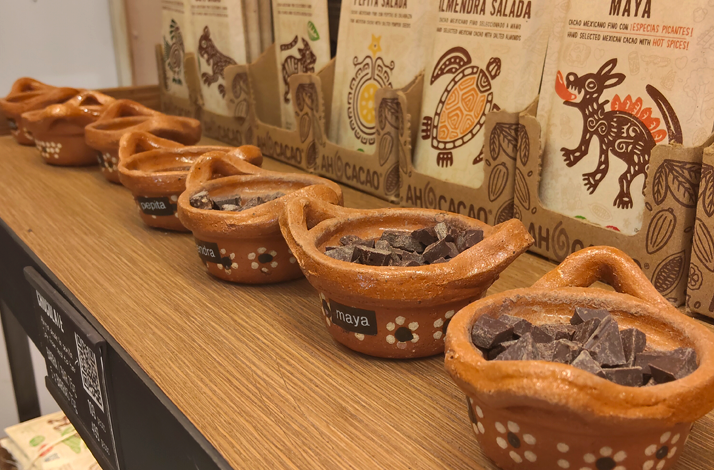 Traditional clay pots filled with artisanal chocolate pieces.
