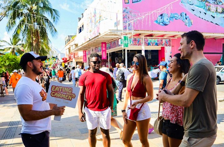 Small group exploring vibrant street art and local culture with a guide in Playa del Carmen during the Hidden Flavors of the Caribbean food tour.