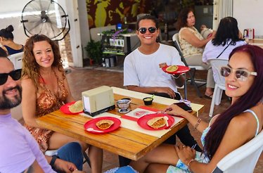 Travelers enjoying tacos at a local eatery during a Cancun food tour, discovering authentic flavors and everyday traditions.