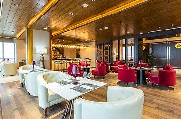 Modern interior of Silk Road Samarkand, showcasing wooden panel design and leather seatings.
