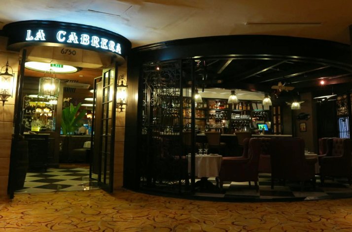 Illuminated 'La Cabrera' sign above the entrance to restaurant La Cabrera Manila.